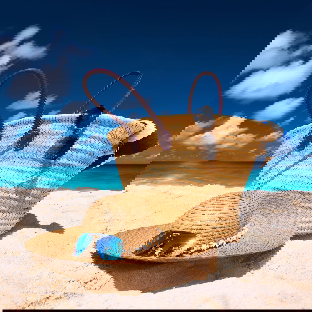 Similar – Image, Stock Photo Several beach accessories, bag, hat and color towel put on the sand close to the sea water