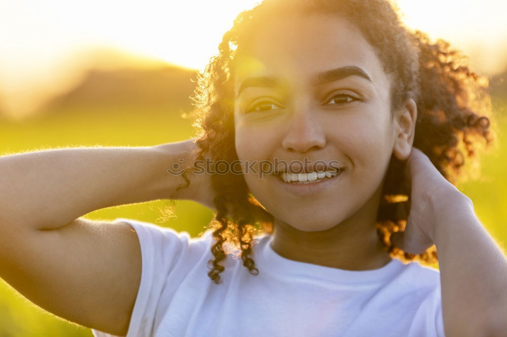 Similar – Young black woman with afro hairstyle smiling in urban park