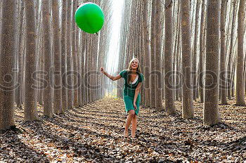 Similar – Beautiful blonde girl, dressed in green, standing in the forest