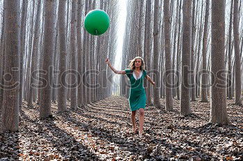 Similar – Beautiful blonde girl, dressed in green, standing in the forest