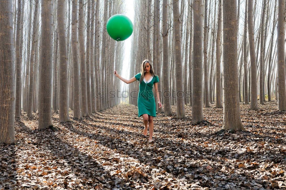 Similar – Beautiful blonde girl, dressed in green, standing in the forest