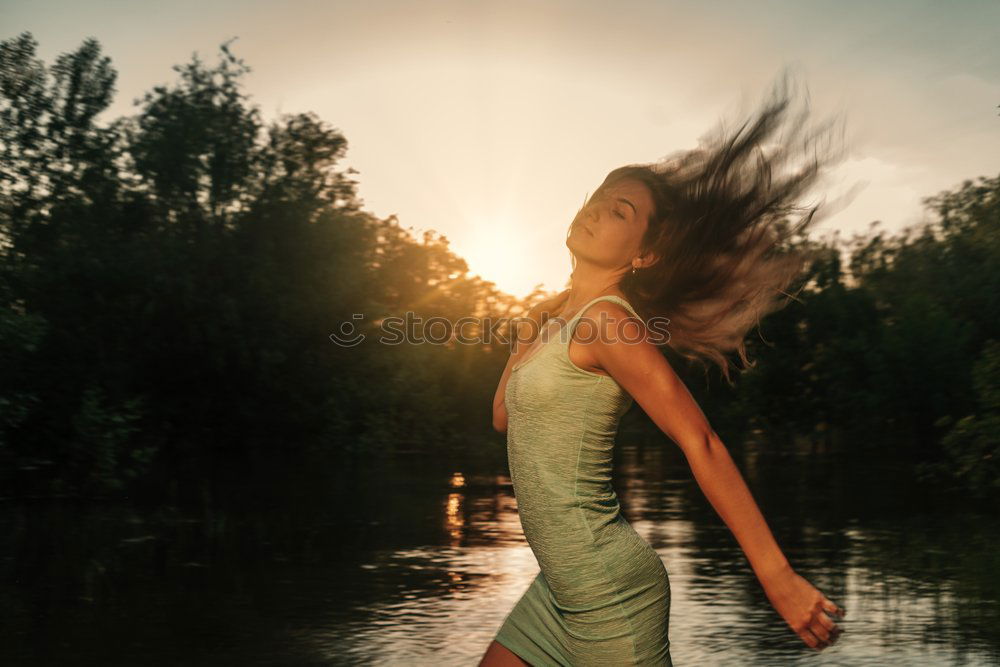 Similar – Woman looking out through a bridge, with a hand floating in the air.