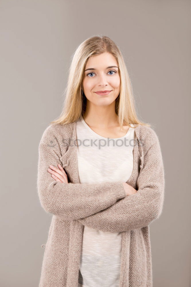 Similar – Young blonde woman smiling near a brick wall