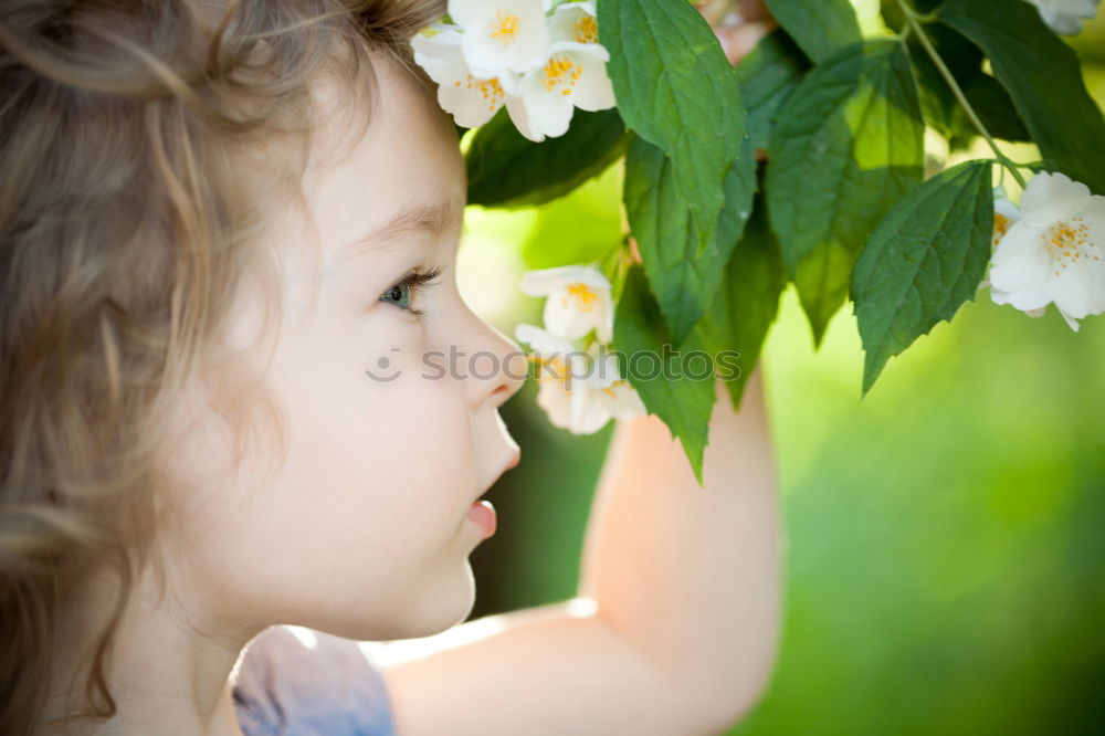 Similar – little girl observing flowers