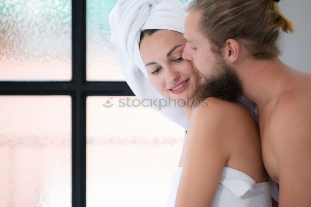 Happy couple embracing on bed