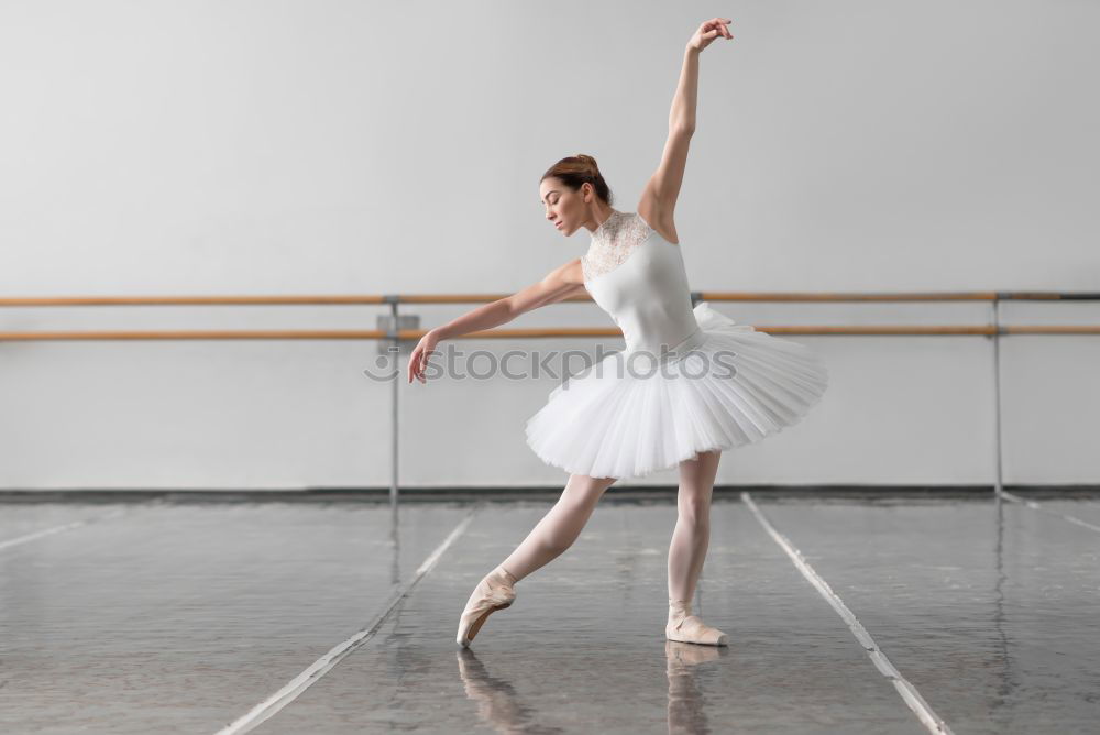 Similar – Top view at ballet dancer tying slippers around her ankle