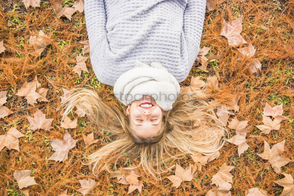 Similar – Image, Stock Photo Young woman lying down in the floor full of autumn leaves