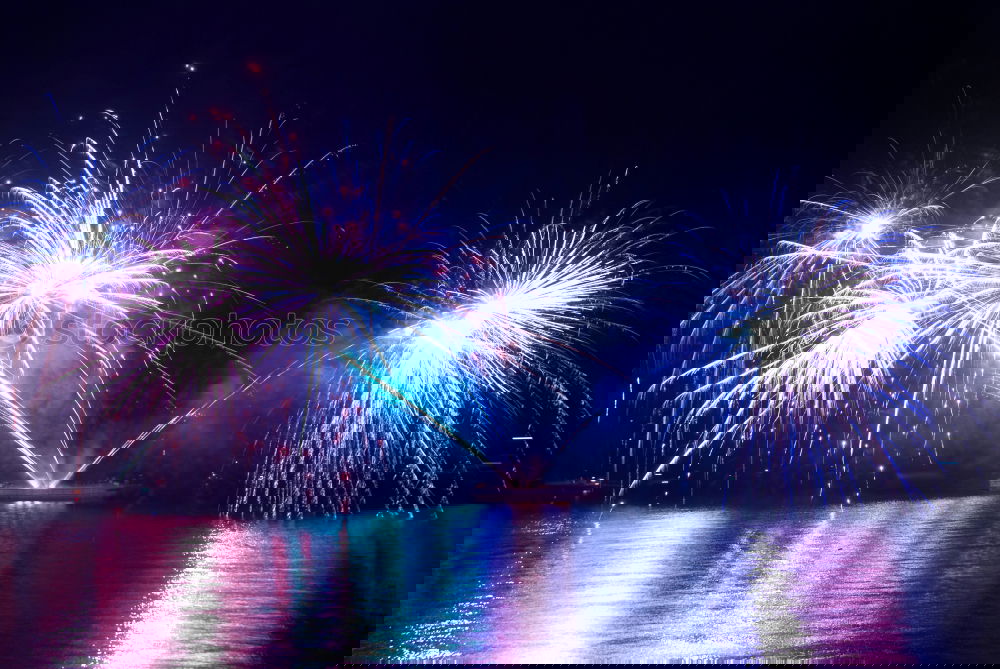 Similar – Image, Stock Photo Blue colorful fireworks on the black sky with water reflection