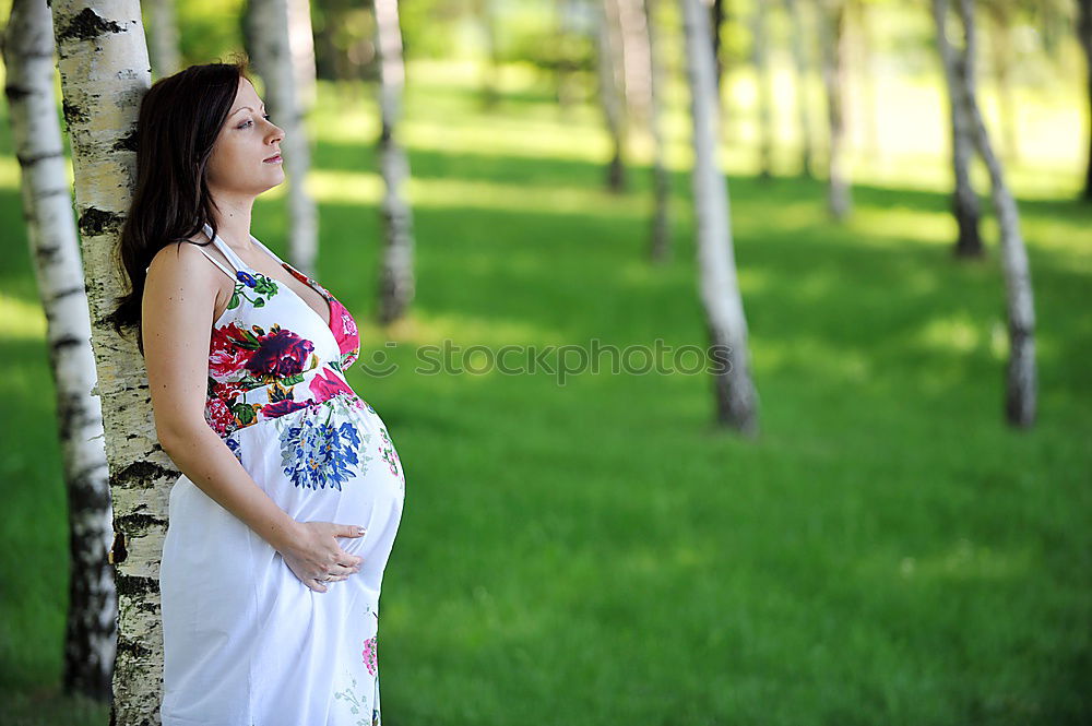 Similar – Image, Stock Photo Closeup shot of bare belly of pregnant woman. She’s holding a flower by it.