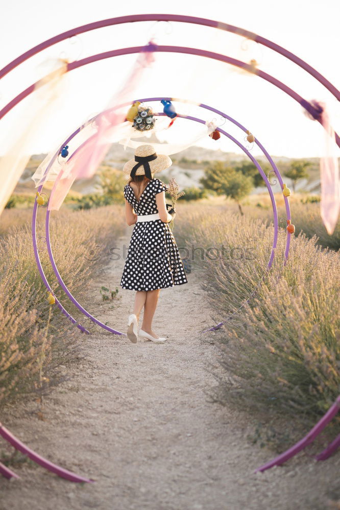 Similar – Woman throwing up hat in nature