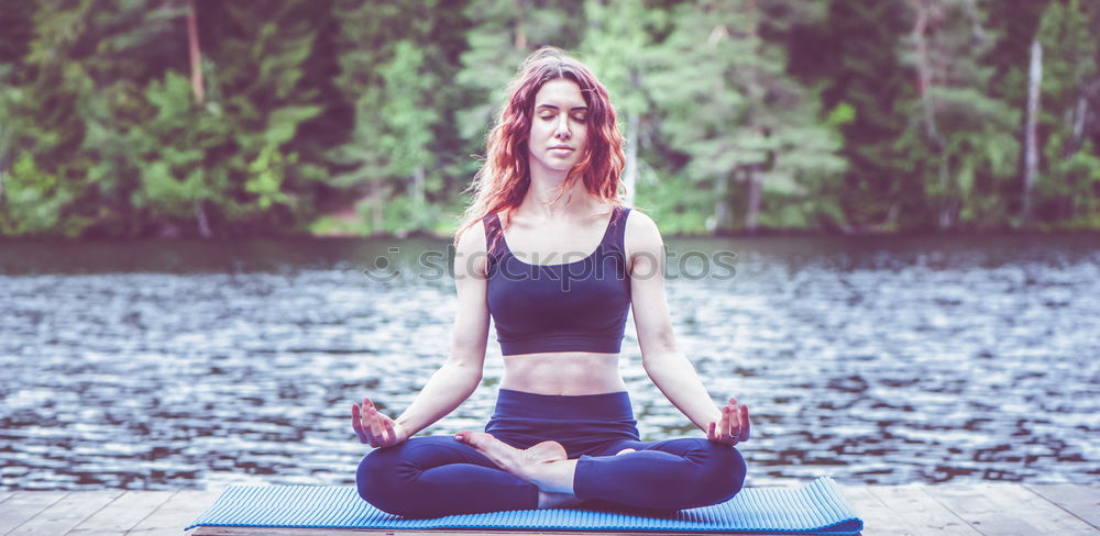 Young woman meditates in yoga asana Padmasana