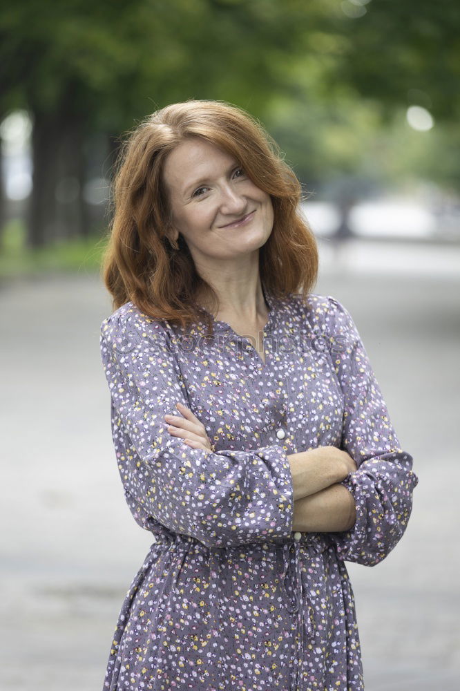 Similar – Portrait of an elderly woman with long red hair, looking mischievously to the side, with red jacket, black shirt and colourful necklace