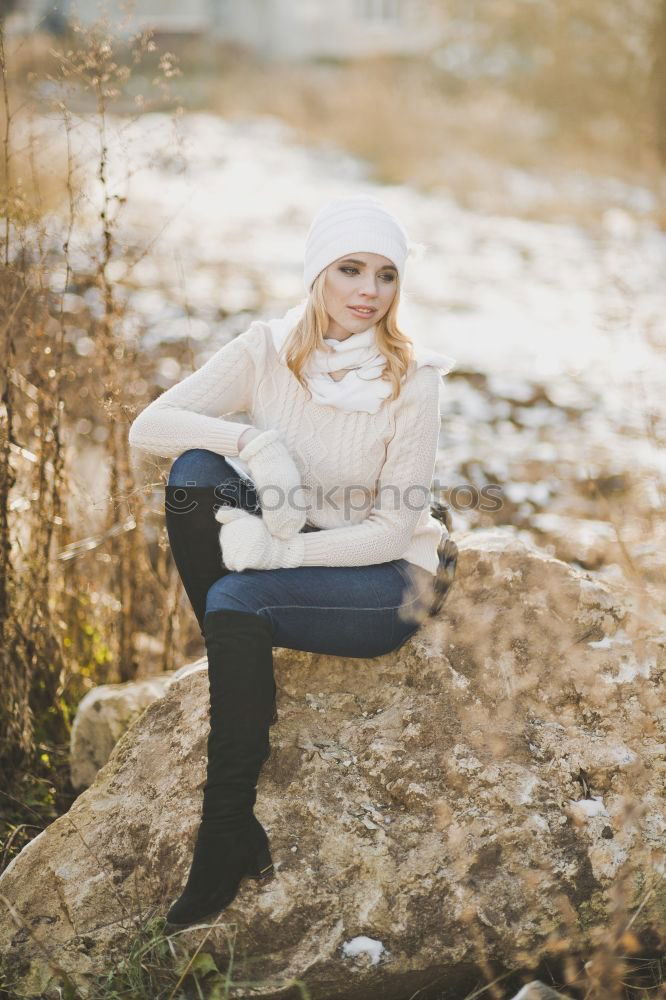 Similar – Young woman sitting leaning against a wall in the shade