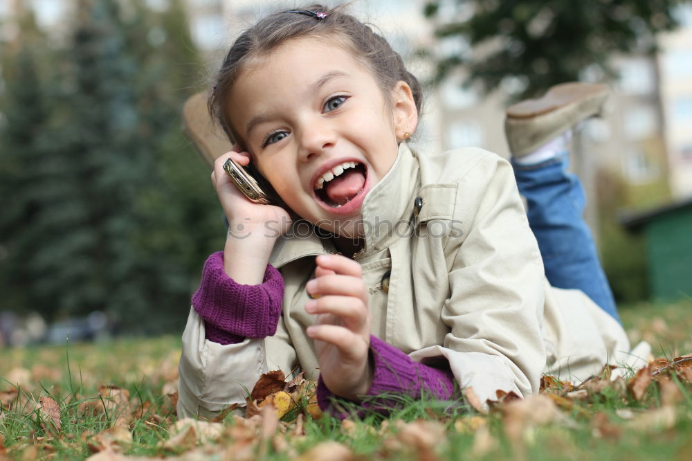 Similar – Image, Stock Photo Small baby playing with toy sitting on the ground in the park and looking to the camera