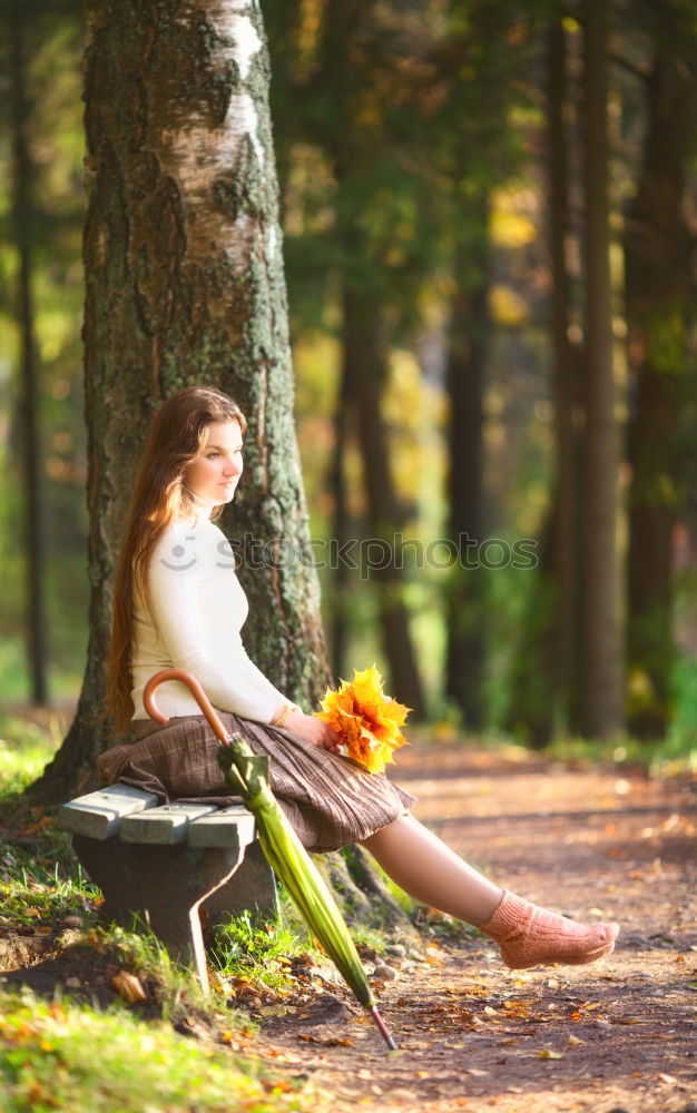 Similar – Woman relaxing on tree trunk