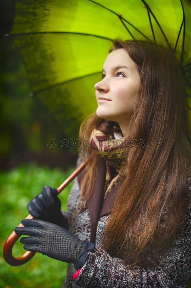 Similar – View through, portrait of young woman in dense vegetation