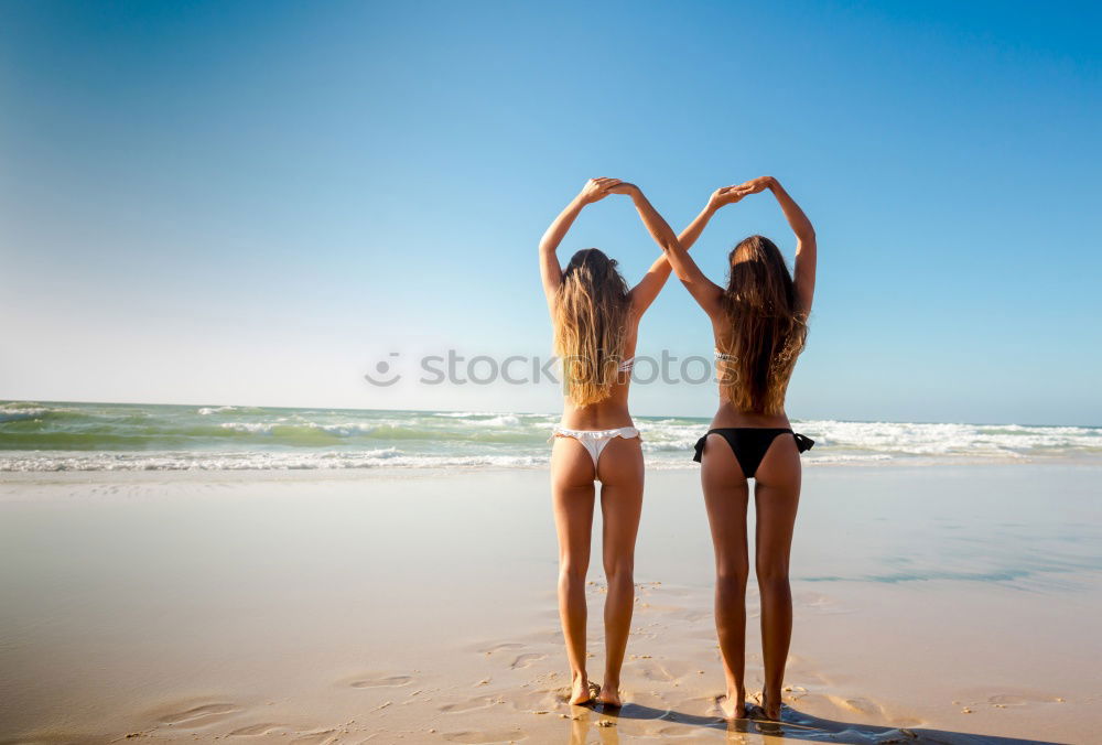 Similar – Image, Stock Photo Two young women in bikini having fun on a tropical beach