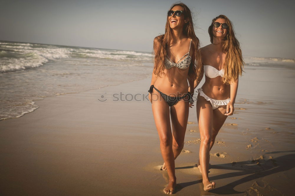 Similar – Group of female friends walking on the beach in sunset