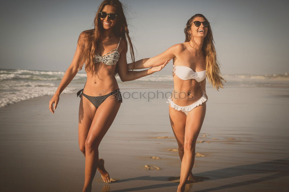 Similar – Group of female friends walking on the beach in sunset