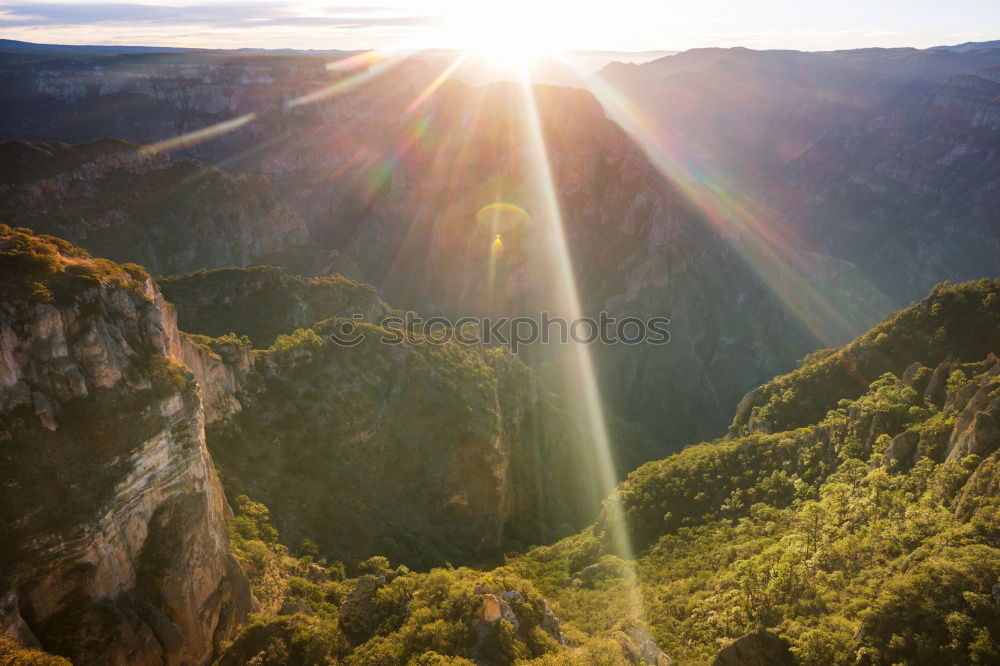 Similar – A steep cliff seen from above with a vast expanse of fields full of trees below