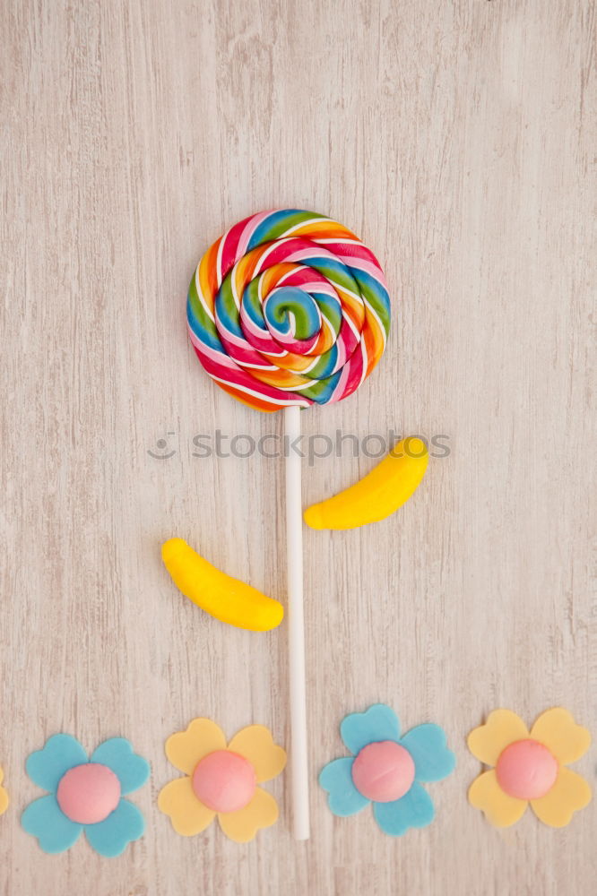 Woman hand holding three colorful lollipops