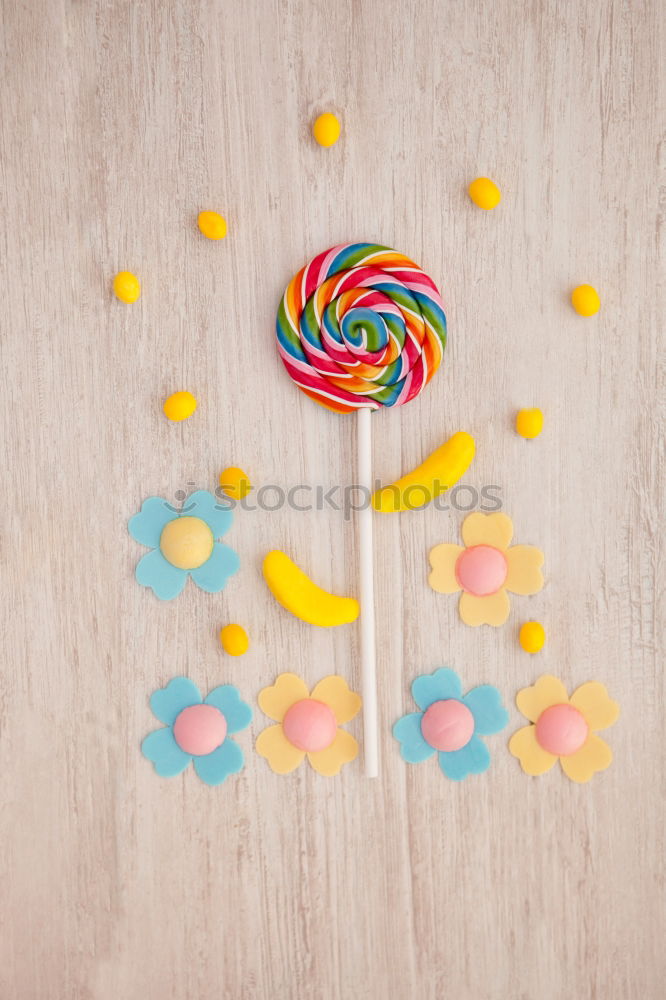 Similar – Woman hand holding three colorful lollipops