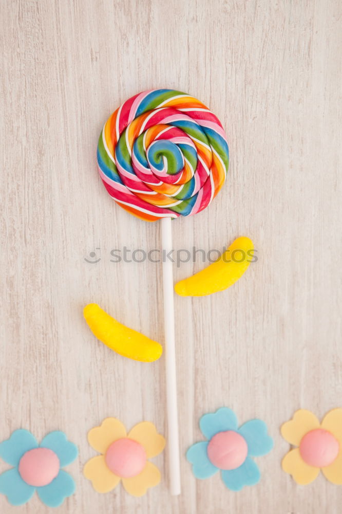 Similar – Woman hand holding three colorful lollipops