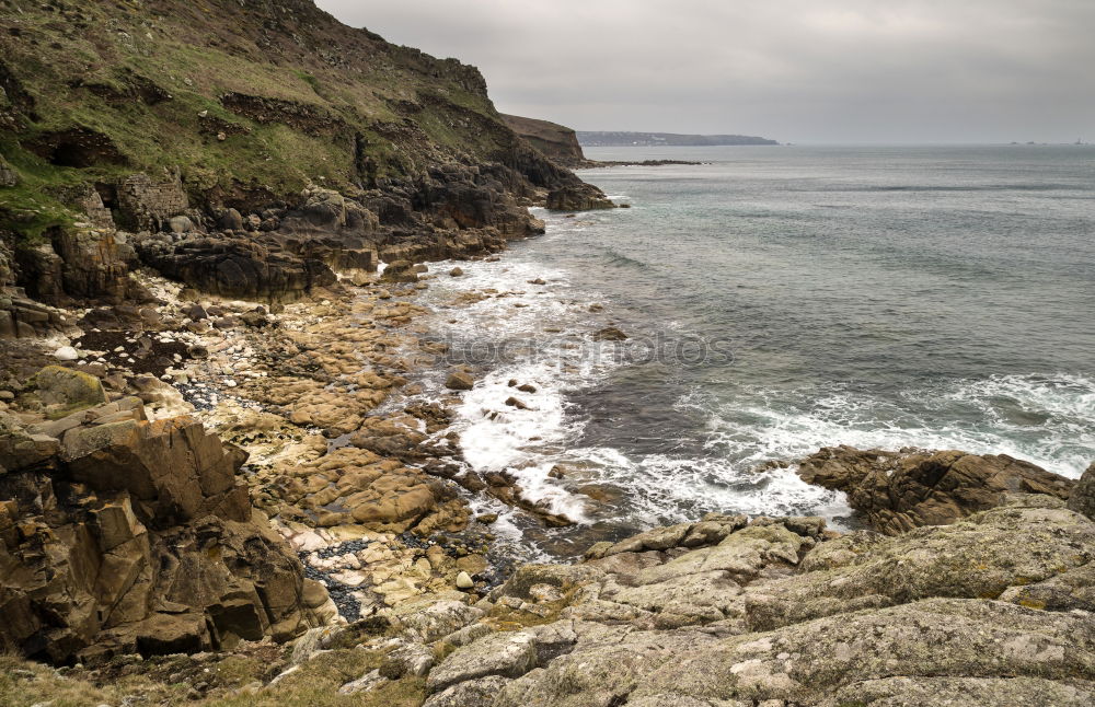 Similar – Beach landscape with cliffs