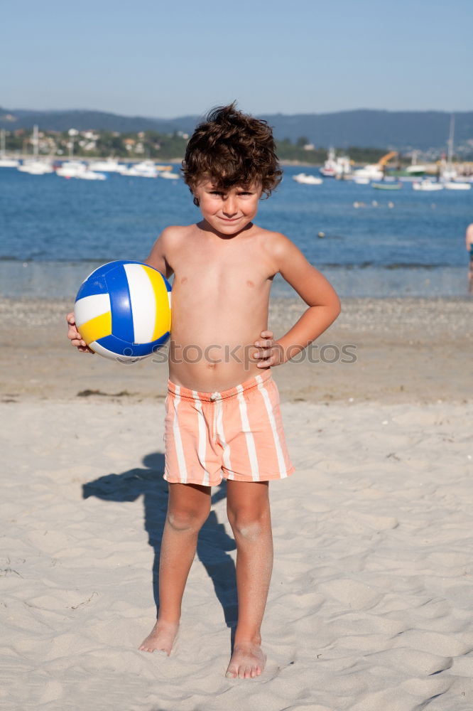 Similar – little girl stands on beach in a special swimsuit for children who can not swim. child in swimsuit, which he kept afloat