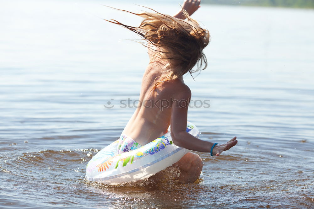 Similar – Image, Stock Photo Boy on plastic swimming aid in the lake