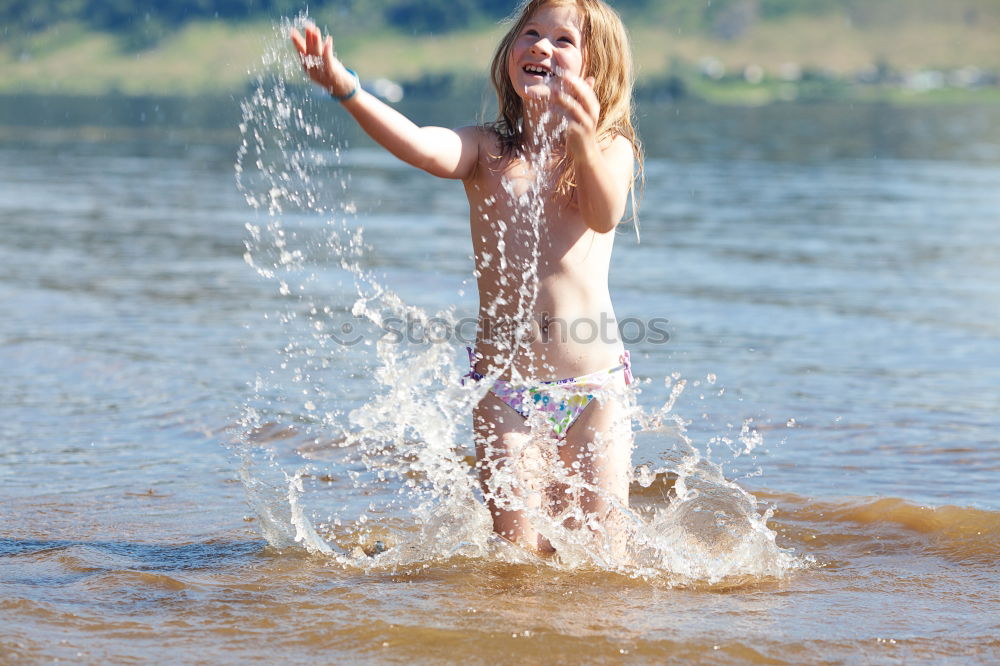 Similar – Playful girl standing in pier near lake