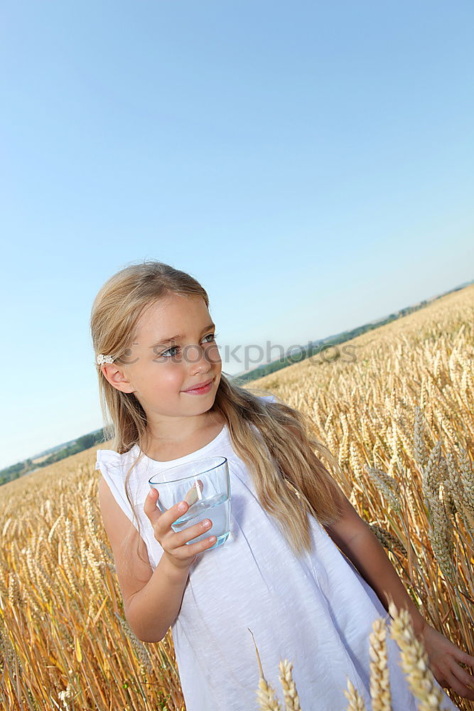 Similar – Image, Stock Photo smiling little girl holding wheat in hands