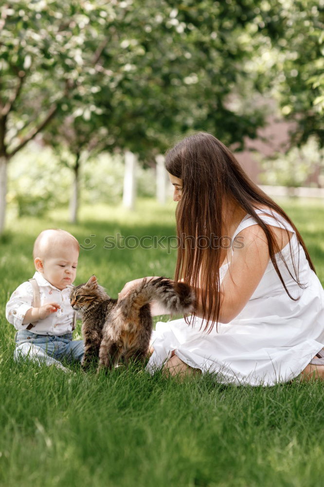 Similar – Mom reading a book her little daughter