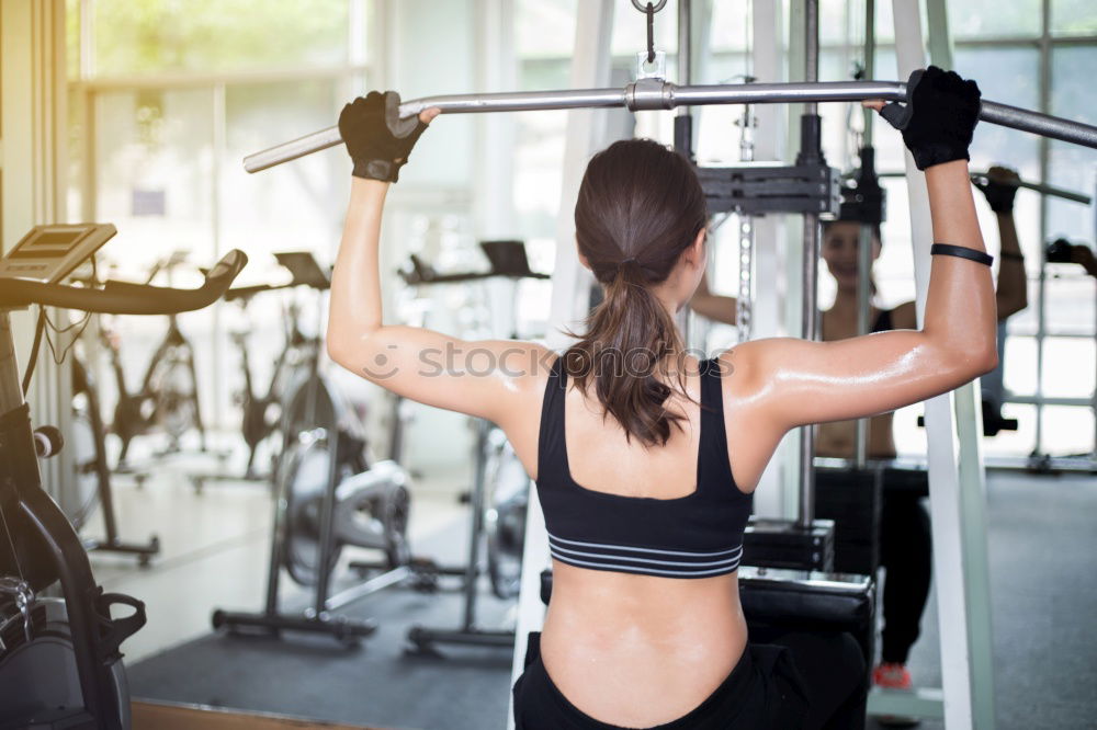 Similar – Sporty woman sitting with dumbbells and smartphone in gym floor