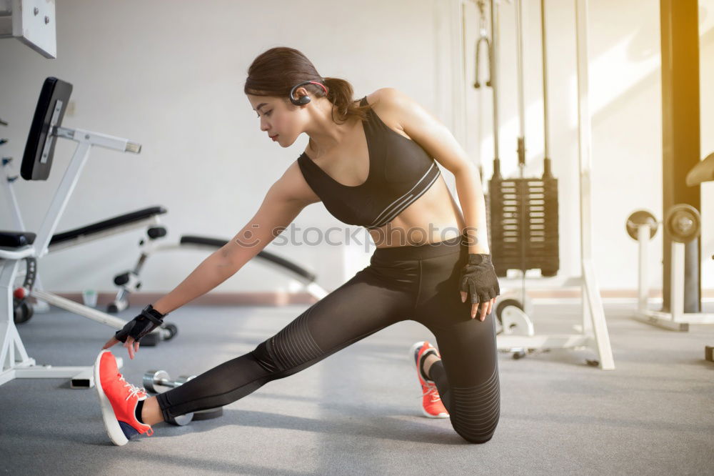 Similar – Sporty woman sitting with dumbbells and smartphone in gym floor