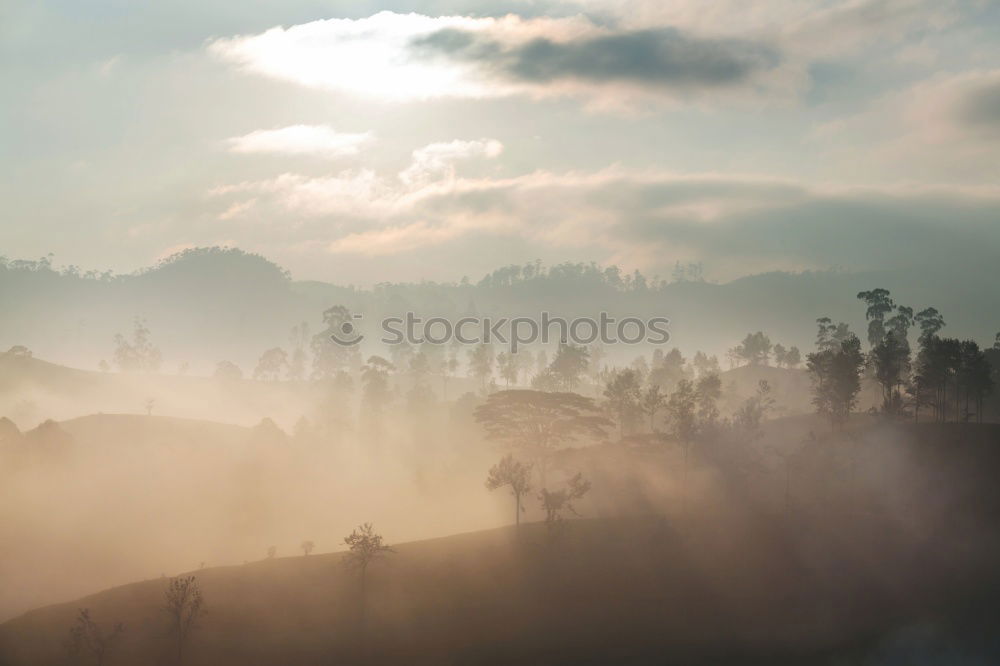 Similar – Alpine village in mountains. Smoke, bonfire and haze