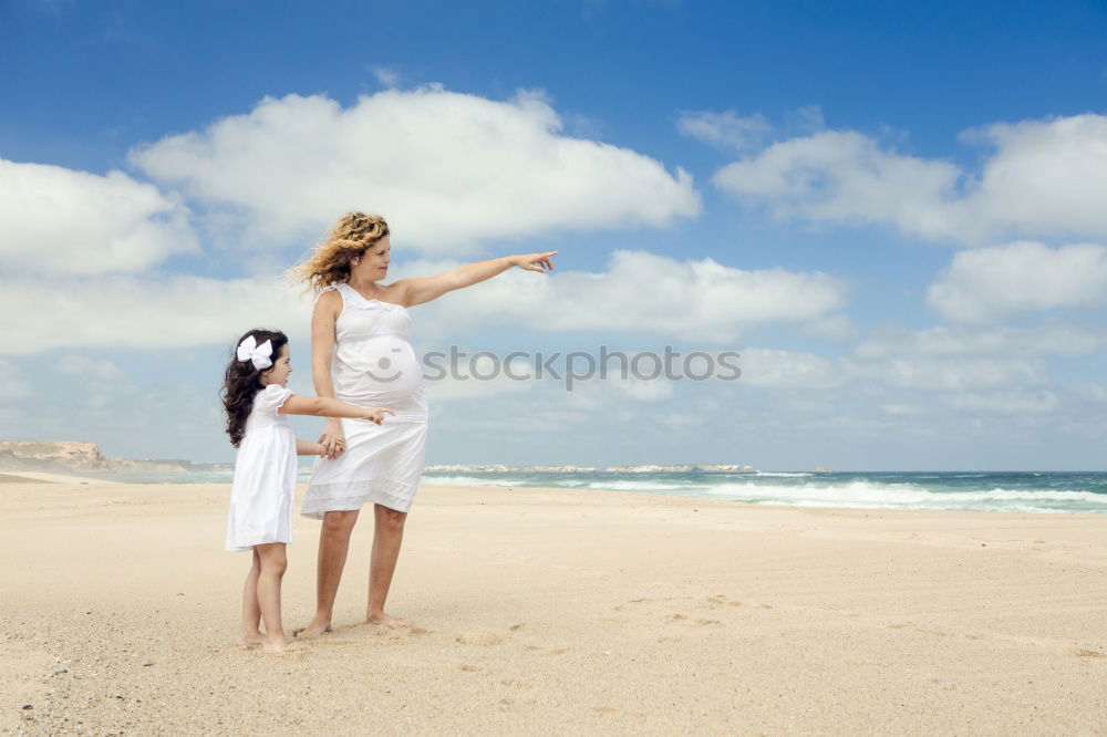 Similar – mother and sun having a walk at the beach