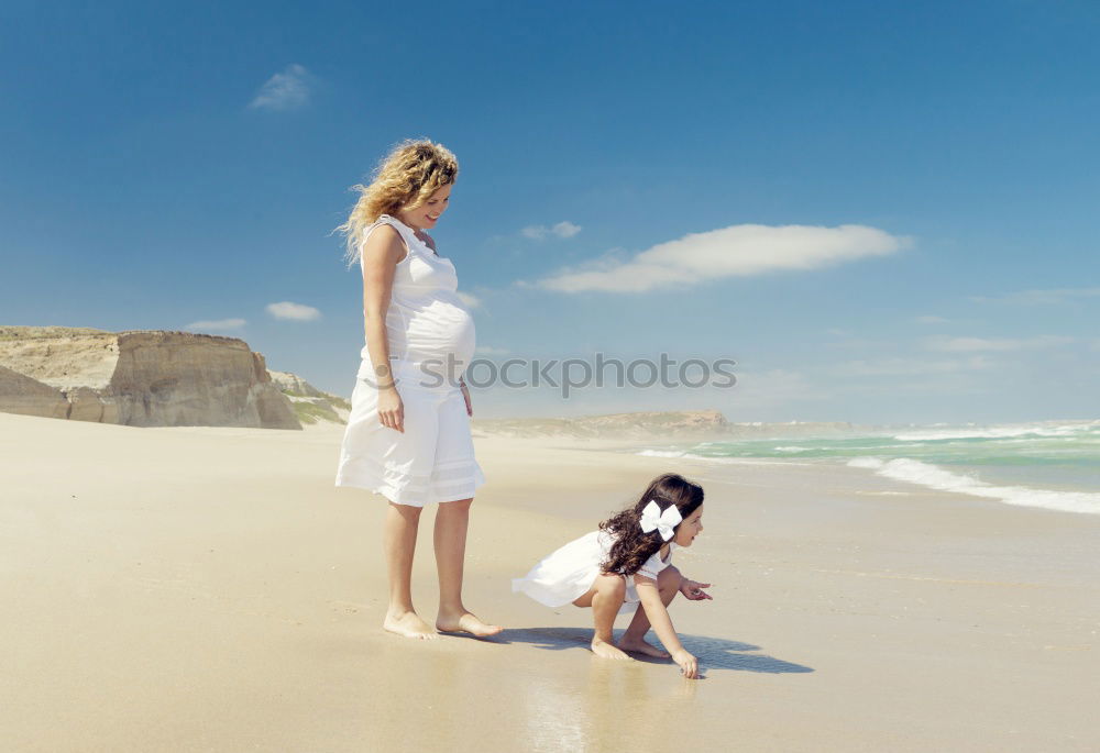 Similar – mother and sun having a walk at the beach