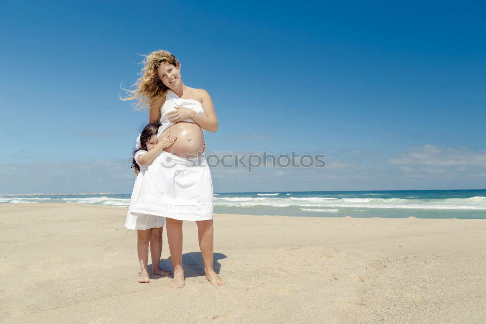 mother and sun having a walk at the beach