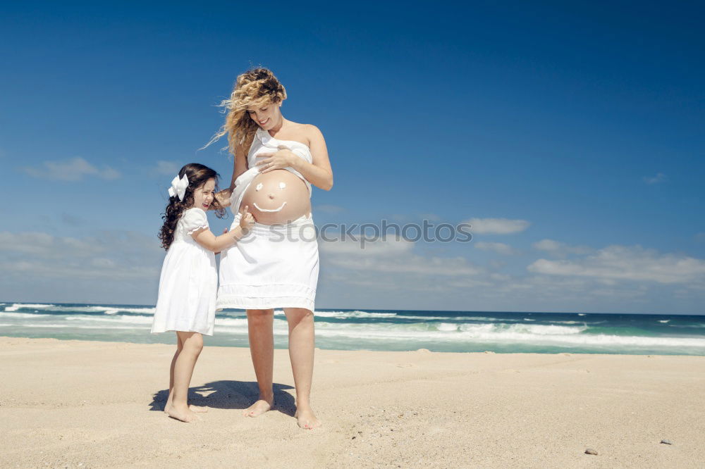 Similar – mother and sun having a walk at the beach