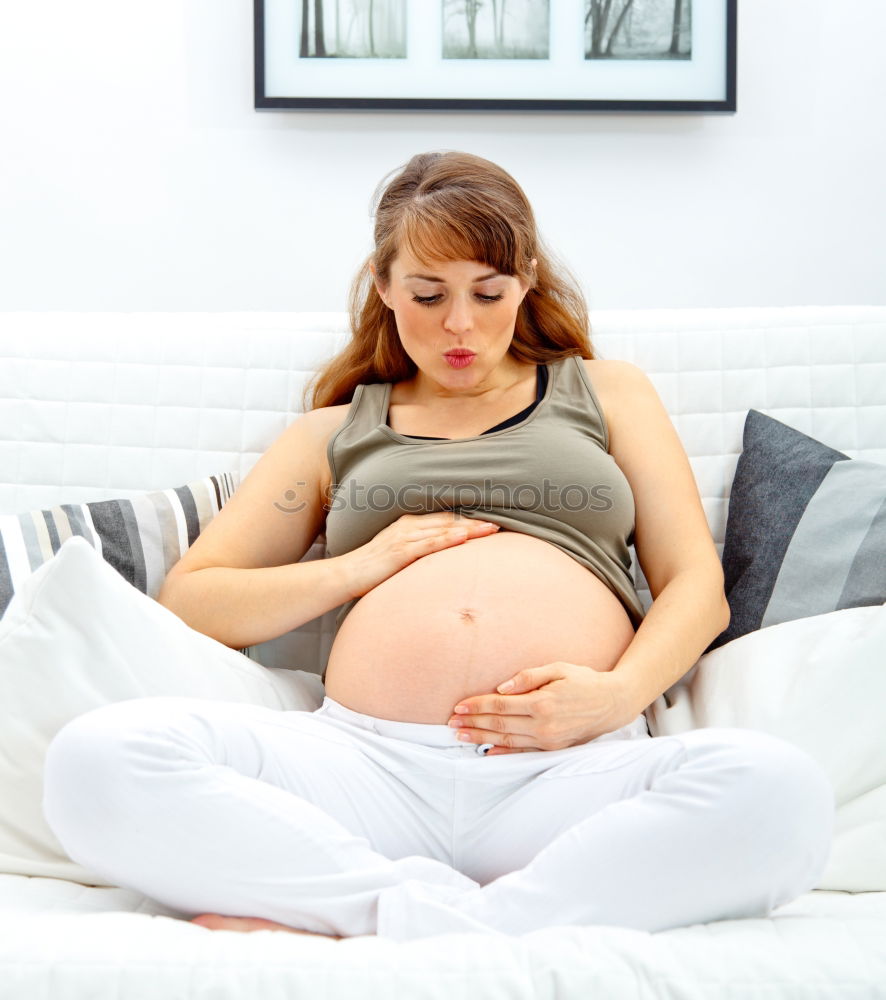 Similar – Pregnant woman touching her belly