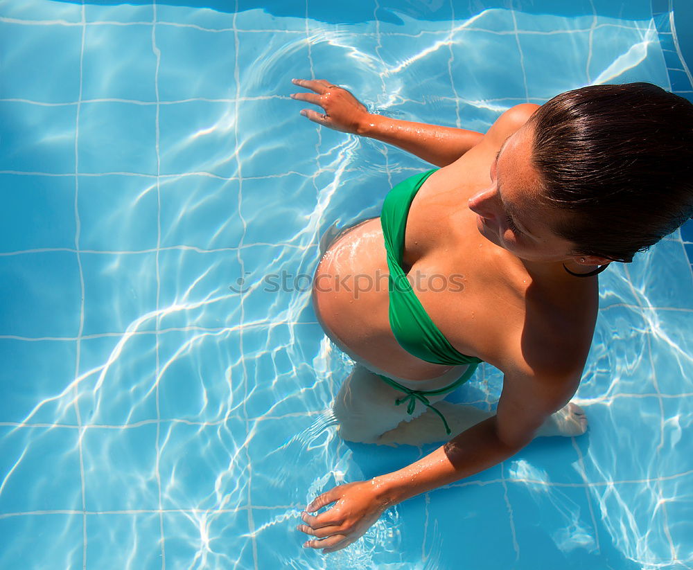 Similar – Image, Stock Photo Happy little girl floating with a ring in the water