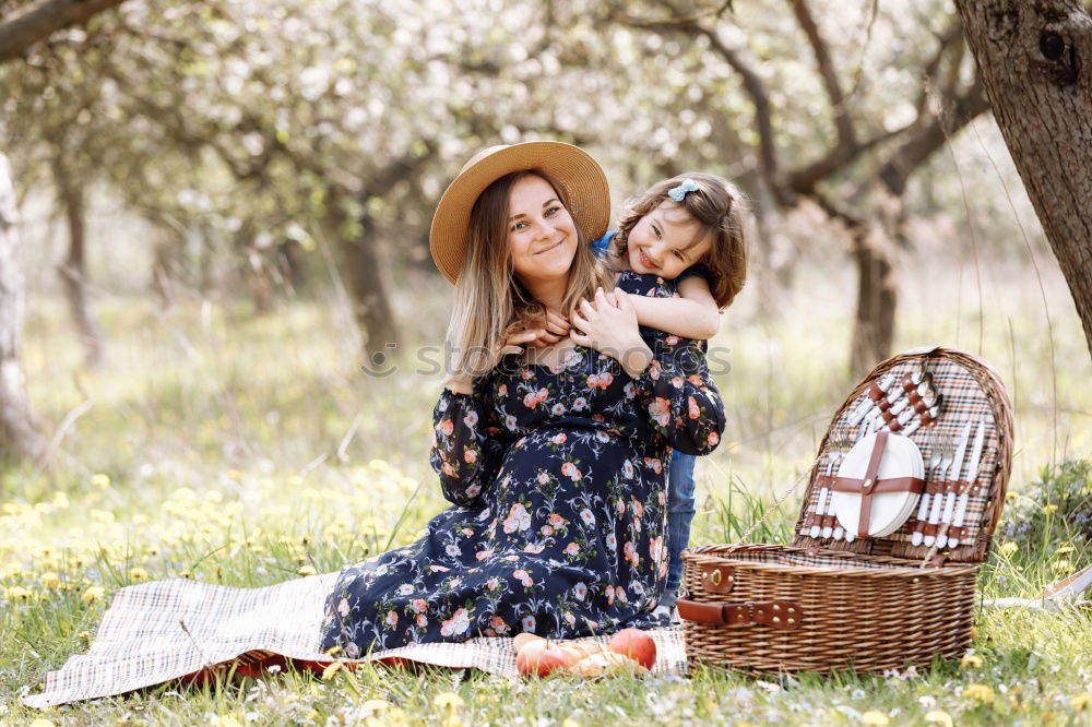 Grandmother with her grandchildren sitting in the field