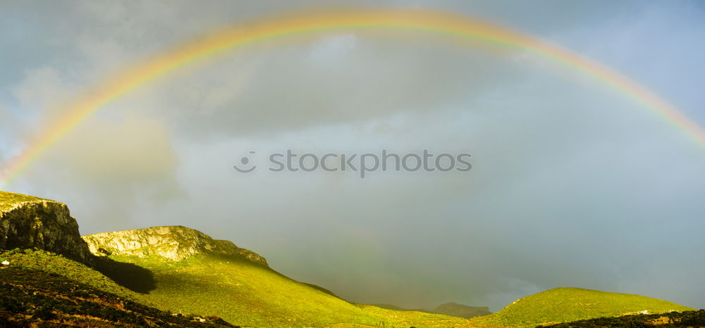 Similar – Image, Stock Photo A man stands at the beginning of a whole rainbow that spans a valley