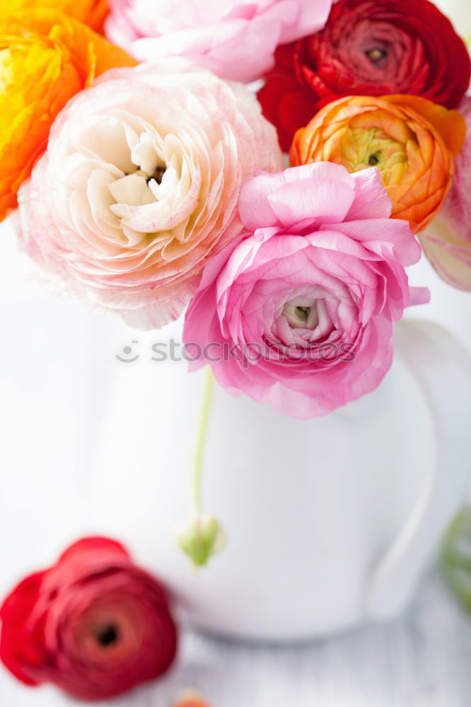 Flowers with bows on white wooden table