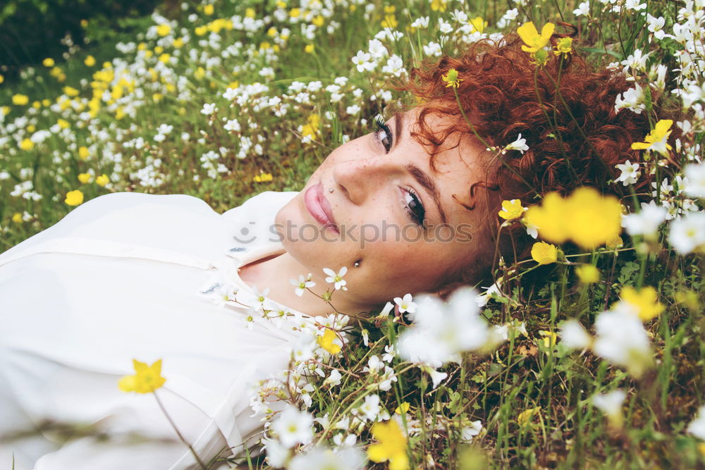 Young woman resting in a field of flowers