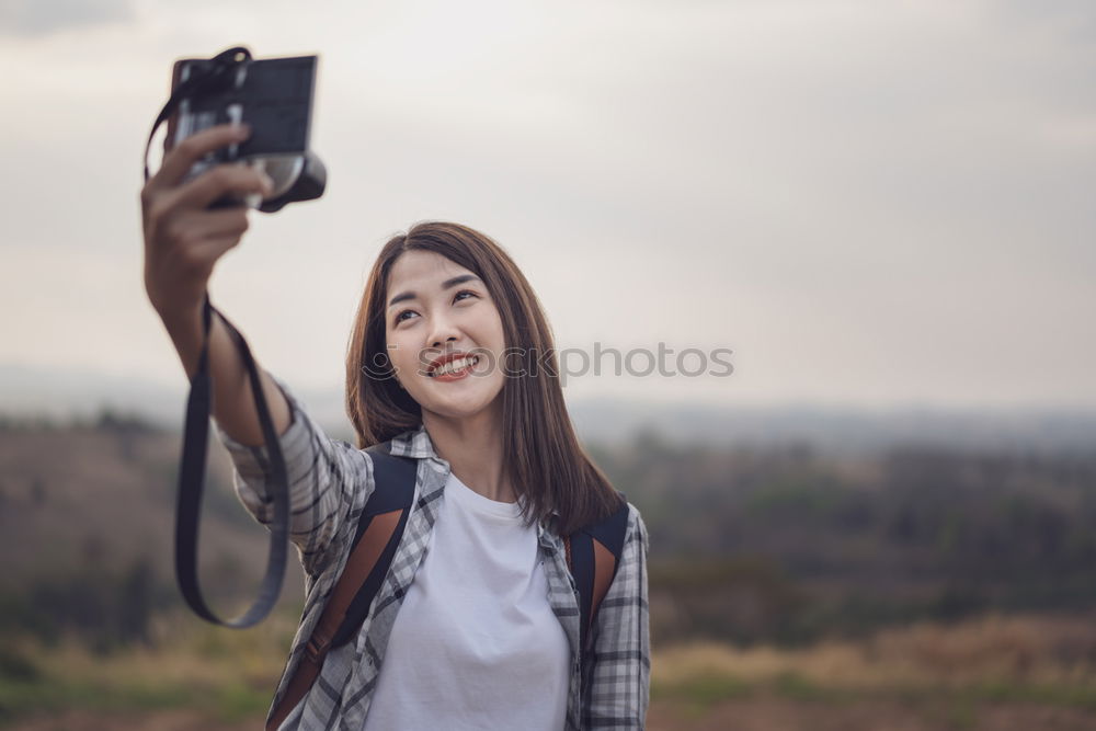 Image, Stock Photo Lady with camera on shore near stones and water