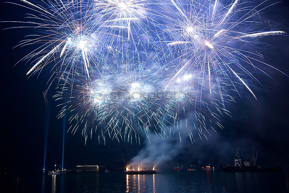 Similar – Image, Stock Photo Blue colorful fireworks on the black sky with water reflection