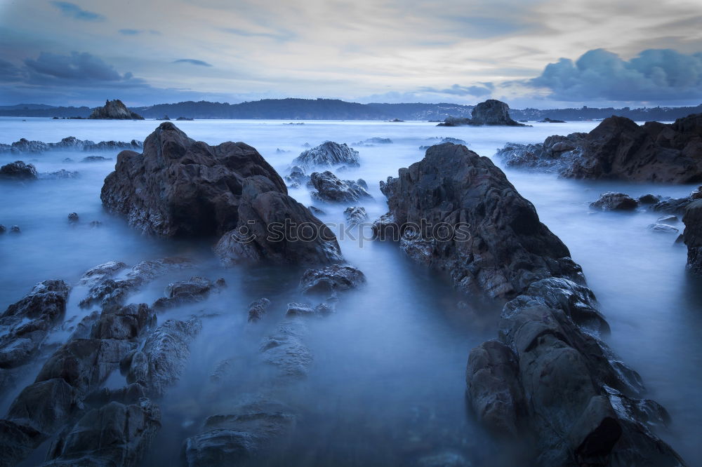 Similar – Rugged coast in the blue sea