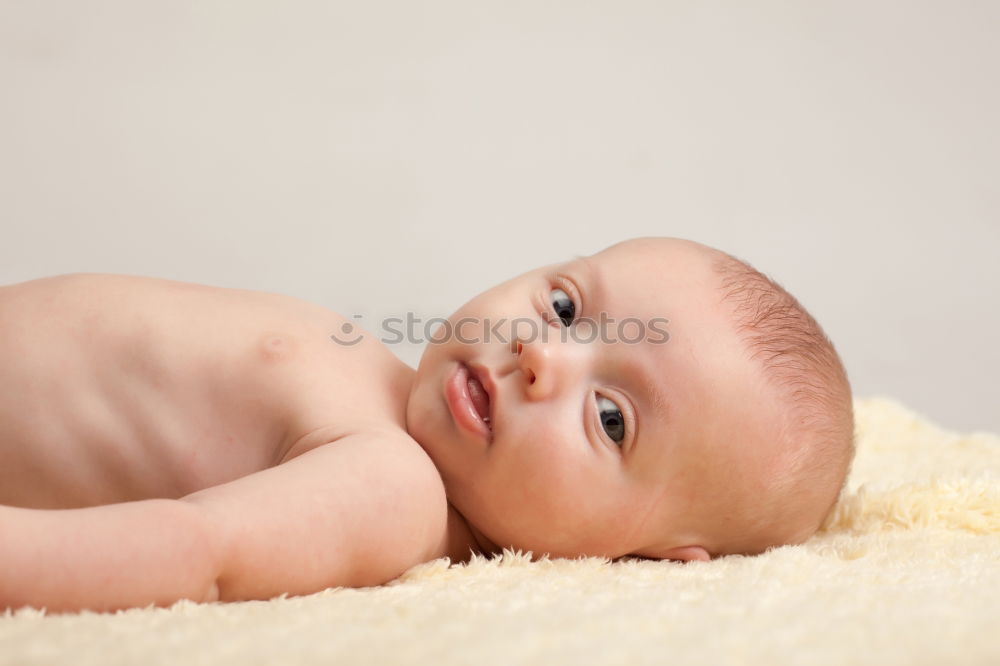 Portrait of a crawling baby on the bed in his room